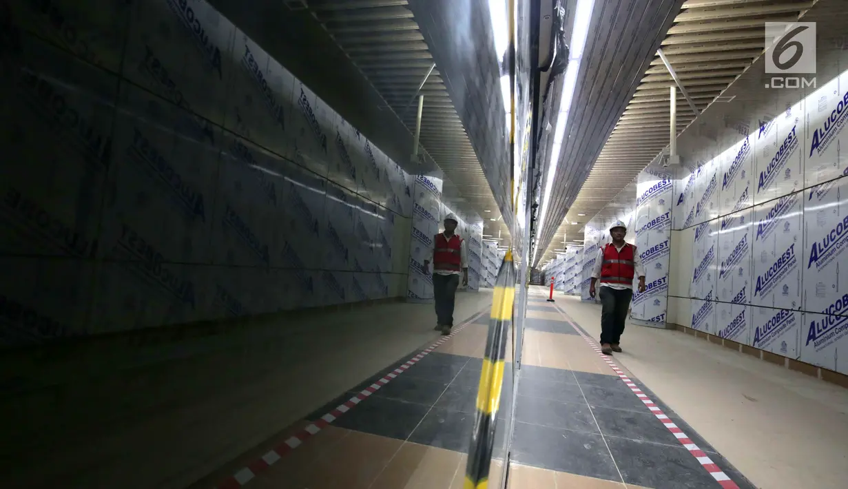 Pekerja melintas di Stasiun Mass Rapid Transit (MRT) Dukuh Atas, Jakarta, Kamis (27/9). Pembangunan konstruksi proyek MRT Jakarta fase satu Lebak Bulus - Bundaran HI lebih maju dibandingkan pembangunan pada akhir Agustus lalu. (Liputan6.com/Angga Yuniar)