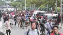 Sejumlah warga lari berhamburan seusai mendengar isu bom yang akan kembali meledak pasca terjadinya ledakan yang terjadi di Pos polisi dekat pusat perbelanjaan Sarinah, Jalan Thamrin, Jakarta, Kamis (14/1). (Liputan6.com/Angga Yuniar)