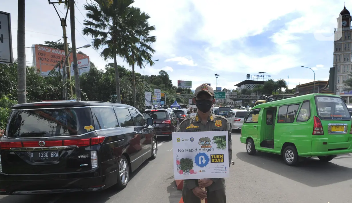 Petugas gabungan Satgas COVID-19 melakukan pemeriksaan dan penyekatan kendaraan di jalur wisata Puncak, Gadog, Bogor, Jawa Barat, Jumat (12/2/2021). Pemeriksaan dan penyekatan sebagai upaya meminimalisir penyebaran COVID-19 saat libur Imlek 2572 dan akhir pekan. (merdeka.com/Arie Basuki)