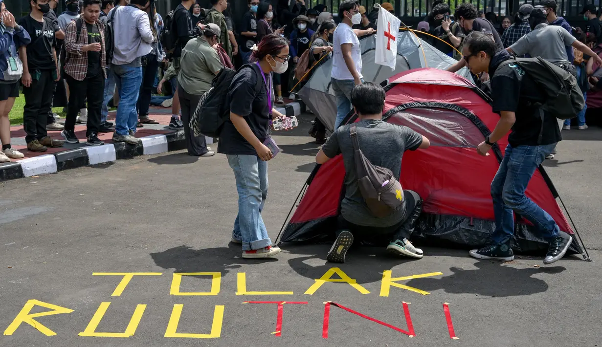 Para mahasiswa memprotes agenda pengesahan Revisi Undang-Undang (RUU) Tentara Nasional Indonesia (TNI) menjadi Undang-Undang di depan gedung Parlemen RI di Jakarta pada tanggal 20 Maret 2025. (BAY ISMOYO/AFP)
