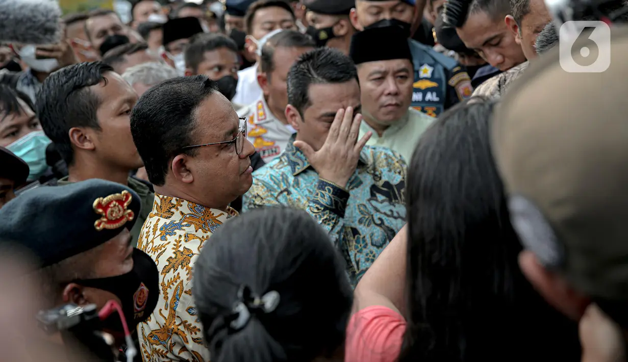 Gubernur DKI Jakarta Anies Baswedan menemui pendemo yang tengah melakukan orasi di depan gerbang Balai Kota DKI Jakarta, Jumat (14/10/2022). Dalam beberapa saat, peserta aksi duduk mendengarkan apa yang dikatakan Anies. (Liputan6.com/Faizal Fanani)