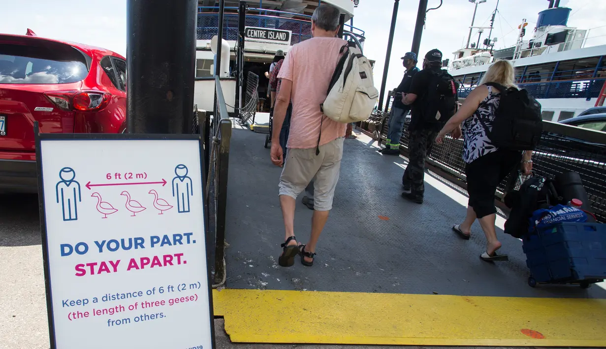 Para penumpang menaiki sebuah kapal feri di Terminal Feri Jack Layton di Toronto, Kanada (27/6/2020). Layanan kapal feri menuju Kepulauan Toronto kembali dibuka untuk umum mulai Sabtu (27/6), dengan mewajibkan penumpang memakai masker atau pelindung wajah. (Xinhua/Zou Zheng)