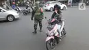 Anggota TNI menghentikan warga yang tidak mengenakan masker saat razia gabungan Kelurahan Gandul di Perempatan Gandul, Cinere, Depok, Kamis ( 29/08/2020). (merdeka.com/Arie Basuki)