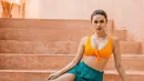 Potret anggun nan memesona Fabienne Nicole dengan summer look. Cropped top oranye dipadunya dengan rok rumbai hijau yang kontras, namun tetap terlihat serasi. [Foto: Instagram/fabienne_fng]