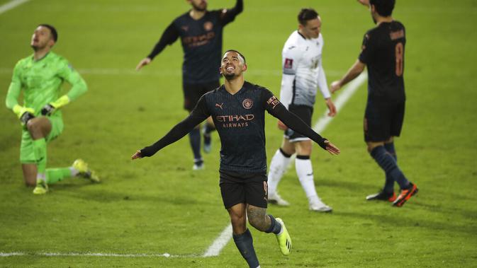 Striker Manchester City, Gabriel Jesus, melakukan selebrasi usai membobol gawang Swansea City pada putaran kelima Piala FA 2020/2021, Kamis (11/2/2021) dinihari WIB. (Nick Potts/PA via AP)