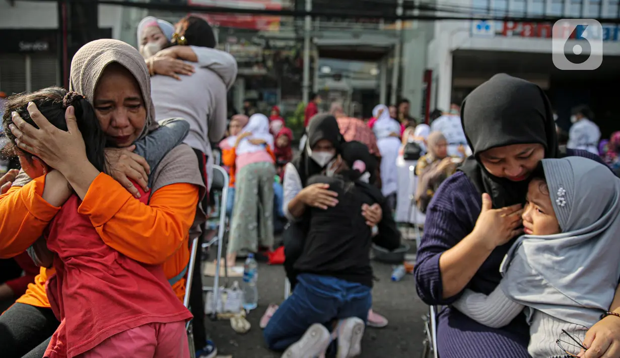 Sejumlah anak memeluk ibunya pada aksi cuci kaki ibu massal di Jakarta, Minggu (18/12/2022). Aksi yang diikuti sebanyak ratusann peserta itu bertujuan untuk meningkatkan rasa cinta kasih kepada ibu , khususnya dalam rangka memperingati Hari Ibu. (Liputan6.com/Faizal Fanani)