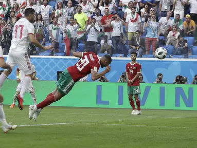 Pemain Moroko, Aziz Bouhaddouz (20) melakukan gol bunuh diri saat melawan Iran pada laga grup B Piala Dunia 2018 di St. Petersburg Stadium, Rusia, (15/6/2018). Iran menang 1-0. (AP/Themba Hadebe)