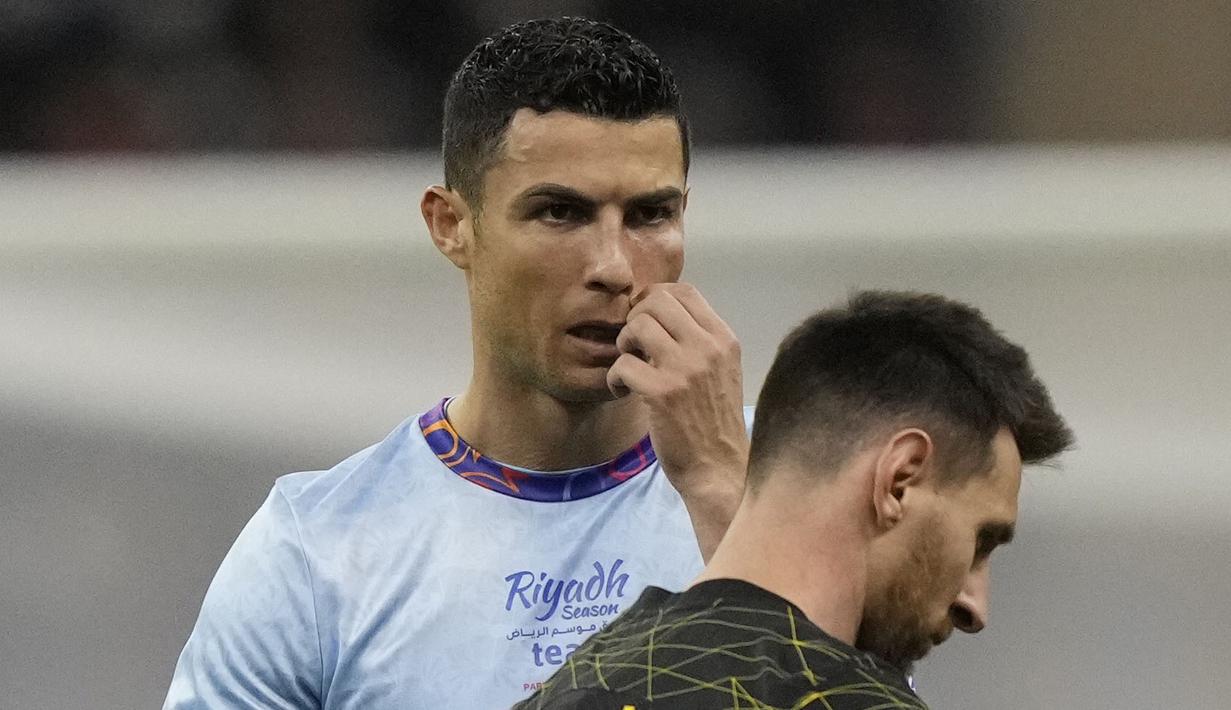 Pemain Paris Saint-Germain (PSG), Lionel Messi bersama pemain Riyadh All-Star, Cristiano Ronaldo, pada laga persahabatan di Stadion Raja Fahd pada Jumat (20/1/2023). Duel Riyadh All-Star XI vs PSG sejak awal memang menjadi ajang reuni antara Ronaldo dan Messi yang selama lebih dari satu dekade terakhir jadi rival sengit. (AP Photo/Hussein Malla)