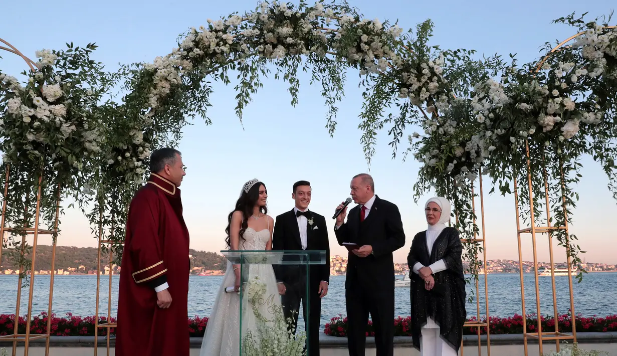 Presiden Turki Recep Tayyip Erdogan (kedua kanan) menghadiri pernikahan gelandang Arsenal asal Jerman, Mesut Ozil dan Amine Gulse di sebuah hotel mewah di Istanbul, Jumat (7/6/2019). Presiden Erdogan mendapat peran istimewa dengan menjadi pendamping Ozil. (TURKISH PRESIDENTIAL PRESS SERVICE/AFP)