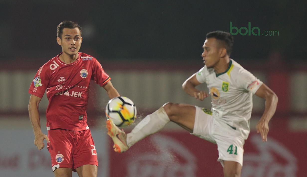 Irfan Jaya (kanan) menghalau bola dari kejaran rekannya di Timnas Indonesia U-23, Rezaldi Hehanussa pada laga Gojek Liag 1 bersama Bukalapak di Stadion PTIK, Jakarta (26/6/2018). Persija dan Persebaya bermain imbang 1-1. (Bola.com/Nick Hanoatubun)