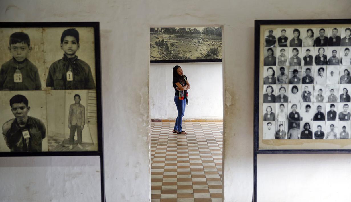 Seorang pengunjung melihat foto-foto korban rezim Khmer Merah di bekas penjara Tuol Sleng yang kini menjadi Museum Genosida di Phnom Penh, (5/8/2014). (REUTERS/Damir Sagolj)