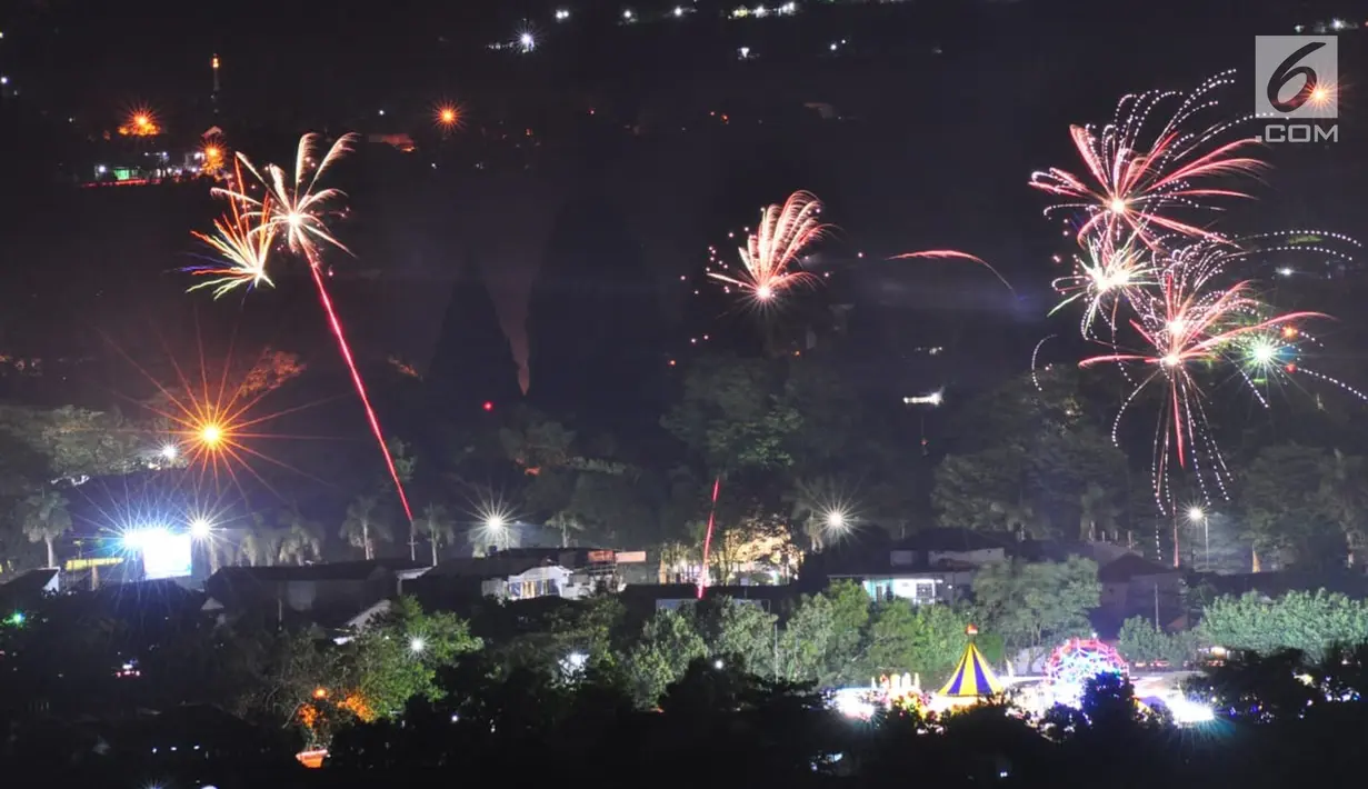 Pesta kembang api saat malam Tahun Baru 2019 di kawasan Candi Prambanan, Klaten, Yogyakarta, Selasa (1/1). Kembang api warna-warni memeriahkan datangnya Tahun Baru 2019. (Liputan6.com/Gholib)