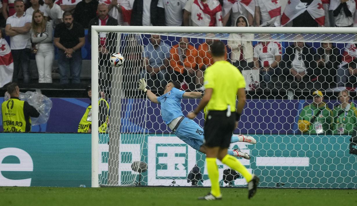 Kiper Timnas Georgia, Giorgi Mamardashvili kebobolan gol kedua yang dicetak lewat tendangan dari luar kotak penalti oleh striker Timnas Turki, Arda Guler pada laga matchday pertama Grup F Euro 2024 di Westfalenstadion, Dortmund, Jerman, Selasa (18/6/2024). (AP Photo/Martin Meissner)
