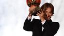 Gelandang Real Madrid, Luka Modric mengangkat trofi setelah memenangkan penghargaan Ballon d'Or 2018 di Grand Palais, Paris, Senin (3/12). Modric sukses memutus dominasi Cristiano Ronaldo dan Lionel Messi yang bertahan selama satu dekade (FRANCK FIFE/AFP)