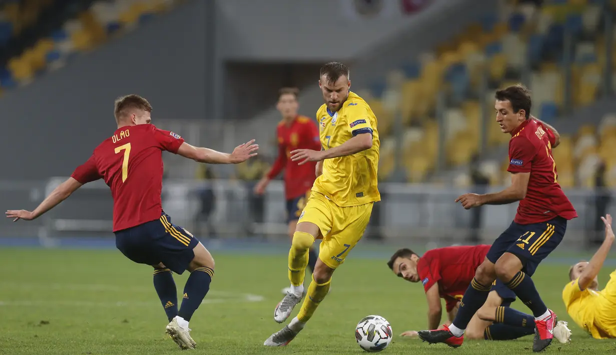 Pemain Ukraina Andriy Yarmolenko (tengah) mencoba menggiring bola melewati pemain Spanyol Dani Olmo (kiri) dan Mikel Oyarzabal pada pertandingan UEFA Nations League di Olimpiyskiy Stadium, Kyiv, Ukraina, Selasa  (13/10/2020). Ukraina memenangkan pertandingan tersebut 1-0. (AP Photo/Efrem Lukatsky)