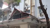 Seorang pria mengenakan helm keluar dari gedung Universitas yang rusak akibat gempa berkekuatan magnitudo 6,8 di Ambon, kepulauan Maluku (26/9/2019). Menurut BMKG, gempa tidak berpotensi tsunami,". (AFP Photo/Yusnita)