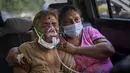 Seorang pasien COVID-19 menerima oksigen di dalam mobil yang disediakan oleh Gurdwara, rumah ibadah Sikh, di New Delhi, India, 24 April 2021. Gelombang pandemi kedua telah melanda India dengan sangat dasyat dan menyebabkan lonjakan harian lebih dari 300.000 kasus. (AP Photo/Altaf Qadri)