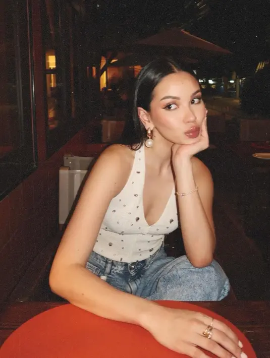 Lagi, cantiknya Alyssa pakai halter-neck top putih dengan manik-manik, dipadunya mengenakan celana panjang jeans. [Foto: Instagram/alyssadaguise]