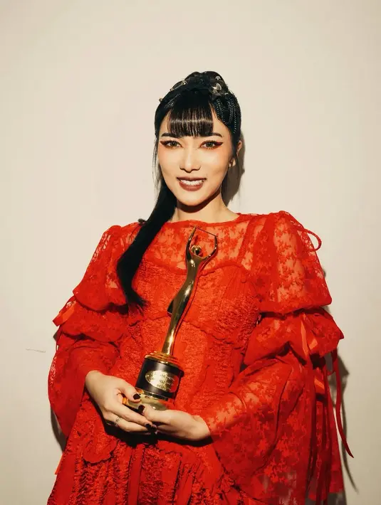 Raih penghargaan atas artis solo rock/instrumental rock terbaik, Isyana Sarasvati tampil bold dengan gaun renda berwarna merah merona. [@isyanasarasvati].