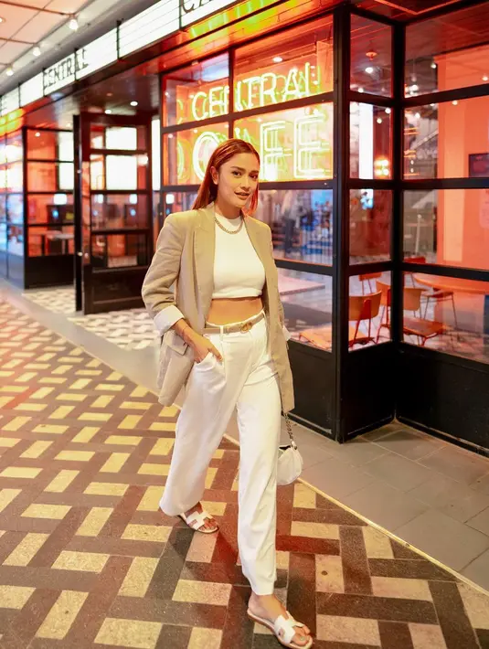 Tampil chic, Andi Annisa padukan crop top dan celana putih dengan blazer cokelat [@andiannsyah]