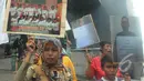 Tampak seorang bocah ikut aksi di depan gedung KPK, Jakarta, Jumat (13/2/2015). Buruh Migran Indonesia sepakat untuk mendukung KPK. (Liputan6.com/Herman Zakharia)