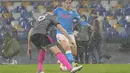 Gelandang Napoli, Piotr Zielinski berusaha melewati bek Leicester City, Jonny Evans pada pertandingan Grup C Liga Europa di Stadion Diego Armando Maradona di Naples, Italia (10/12/2021). Napoli melaju kebabak selanjutnya karena berada diperingkat kedua klasemen. (AP Photo/Gregorio Borgia)