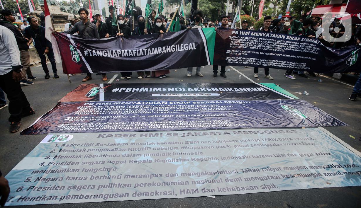Sejumlah massa yang tergabung dalam Himpunan Mahasiswa Islam (HMI) membentangkan spanduk besar bertuliskan tuntutan saat menggelar aksi di depan Patung Kuda, Jakarta, Senin (29/8/2022). Mereka menolak rencana pemerintah untuk menaikkan harga BBM bersubsidi karena akan mengorbankan kondisi ekonomi rakyat, terutama masyarakat kelas menengah ke bawah dan pelaku Usaha Mikro Kecil Menengah (UMKM), yang belum sepenuhnya pulih akibat terpaan pandemi COVID-19. (Liputan6.com/Faizal Fanani)