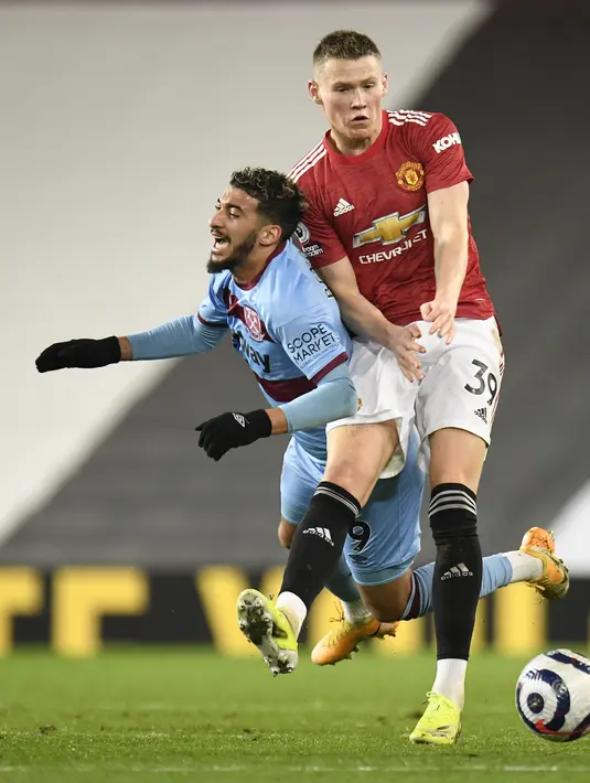 Gelandang Manchester United, Scott McTominay bersaing dengan penyerang West Ham Said Banrahma pada pekan 29 Liga Inggris 2020-2021 di Old Trafford, Senin dinihari WIB (15/3/2021). Manchester United atau MU berhasil mencuri poin penuh usai kalahkan West Ham 1-0. (AP Photo/Peter Powell,Pool)