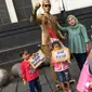 Pengunjung berpose dengan manusia patung di kawasan Museum Fatahilah, Kota Tua, Jakarta, Jumat (16/2). Libur Imlek 2018 dimanfaatkan warga untuk berwisata di sejumlah lokasi, Salah satu yang ramai dikunjungi yakni Kota Tua (Liputan6.com/Immanuel Antonius)