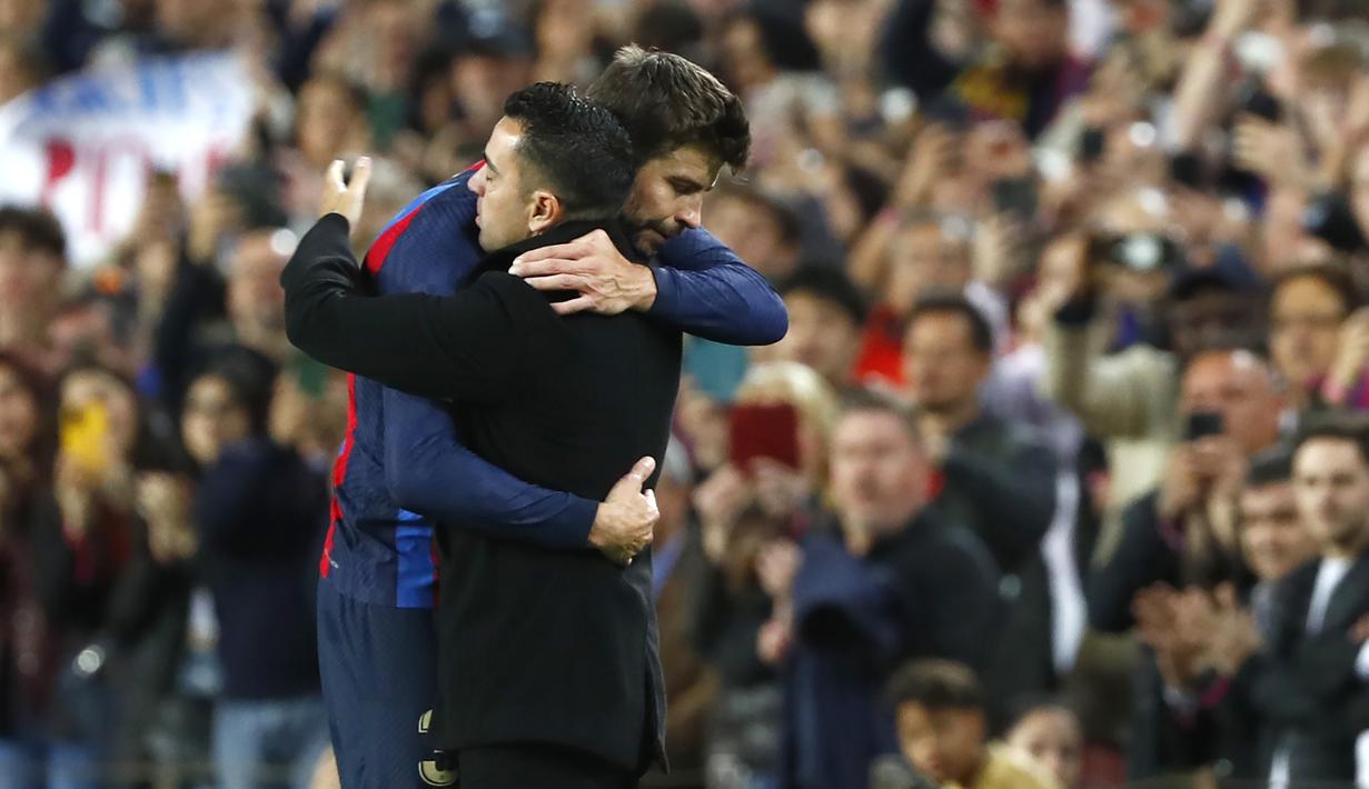 Di pinggir lapangan ia langsung disambut pelukan hangat sang pelatih, Xavi Hernandez yang tak lain adalah mantan rekannya saat masih aktif bermain. (AP/Joan Monfort)