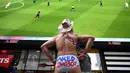 US actor the "Naked Cowboy" watches the 2019 Women's World Cup quarter-final football match between France and the United States on a big screen in Times Square in New York on June 28, 2019. (Photo by TIMOTHY A. CLARY / AFP)