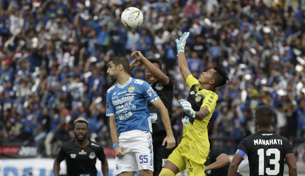 Gelandang Persib Bandung, Srdan Lopicic, duel udara dengan kiper TIRA Persikabo, Angga Saputro, pada laga Piala Presiden 2019 di Stadion Si Jalak Harupat, Bandung, Sabtu (2/3). Persib kalah 1-2 dari TIRA. (Bola.com/Yoppy Renato)