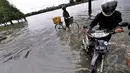 Curah hujan yang tinggi di Jakarta menyebabkan sejumlah kawasan terendam banjir.Sejumlah warga mendorong kendaraannya saat melintasi jalan di sekitar Danau Sunter, Jakarta, Selasa (10/2/2015). (Liputan6.com/Faizal Fanani)