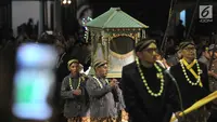 Abdi keraton membawa pusaka saat mengikuti upacara ritual Kirab Pusaka dan Tapa Bisu di Solo, Sabtu (31/8/2019) malam. Kirab tersebut dalam rangka memperingati pergantian tahun baru Hijriah yand dalam penanggalan Jawa disebut satu Suro. (merdeka.com/Iqbal S Nugroho)
