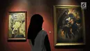 Pengunjung melihat lukisan karya Basoeki Abdullah berjudul "Perkelahian Antara Rahwana dan Jatayu Memperebutkan Sinta" (kanan) dan "Penyelamatan Sinta" karya Ki Heru Wirjono di Galeri Nasional, Jakarta, Senin (6/8). (Merdeka.com/Iqbal Nugroho)