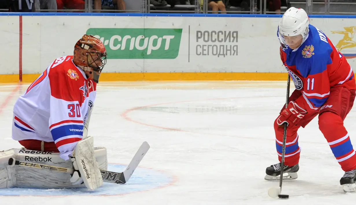Presiden Rusia Vladimir Putin bersiap melakukan pukulan saat bermain hoki es dalam acara gala game Ice Hockey League di Sochi, Rusia, 10 Mei 2016. (Reuters/ Mikhail Klimentyev/Sputnik/Kremlin)