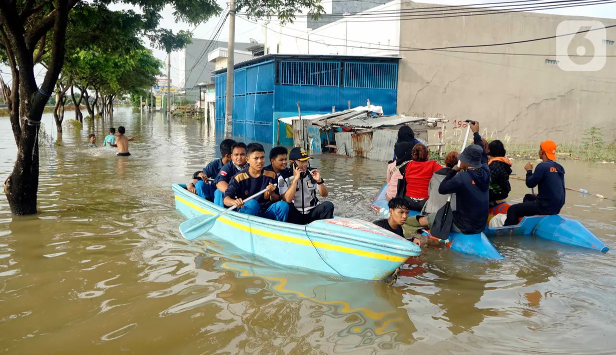 Warga menggunakan perahu karet melintasi banjir yang melanda Perumahan Total Persada, Periuk, Kota Tangerang, Selasa (4/2/2020). Banjir akibat tanggul kali Ledug jebol membuat ratusan rumah di Total Persada terendam banjir hingga mencapai 3,5 meter. (merdeka.com/Arie Basuki)