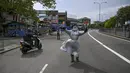 Seorang polisi memberi isyarat kepada pengendara di jalan setelah pemerintah memberlakukan pembatasan perjalanan dan lockdown akhir pekan di Kolombo, Sri Lanka, Sabtu (22/5/2021). Sri Lanka pada Jumat, 21 Mei mencatat 3.547 kasus harian corona Covid-19. (Ishara S. KODIKARA/AFP)