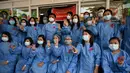 Tenaga medis mengenakan pita merah di seragamnya memberi hormat tiga jari di Rumah Sakit Umum Yangon di Yangon pada 3 Februari 2021 ketika seruan untuk pembangkangan sipil semakin meningkat menyusul kudeta militer yang menahan pemimpin sipil Aung San Suu Kyi. (STR / AFP)