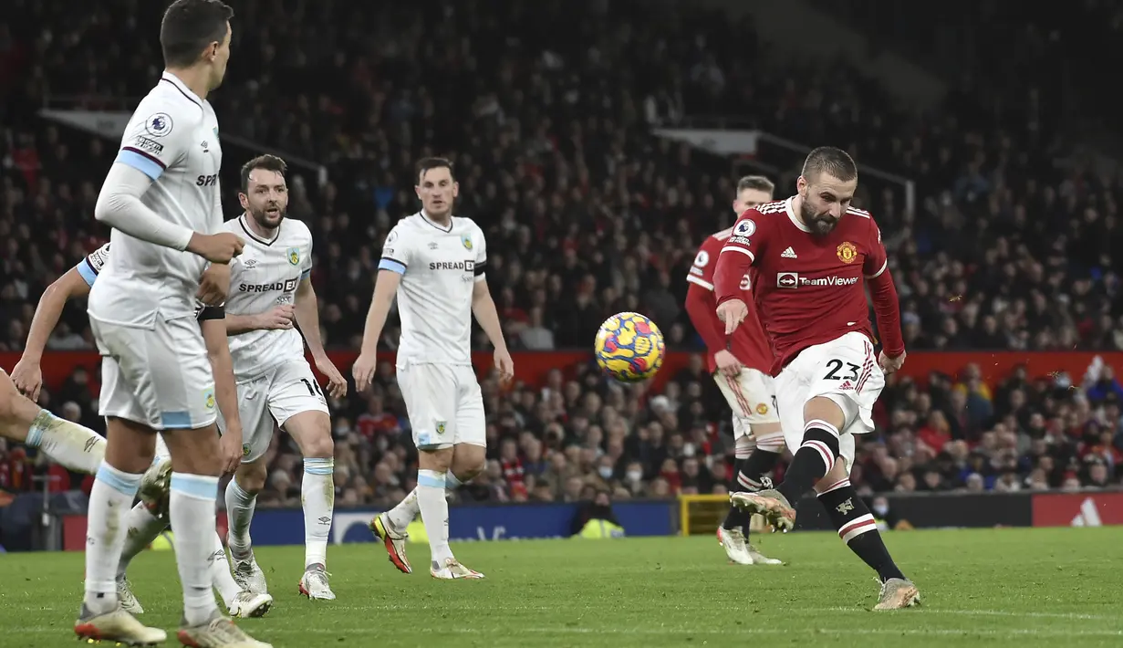 Bek Manchester United, Luke Shaw menembak bola ke arah gawang Burnley pada pertandingan lanjutan Liga Inggris di di Old Trafford, Inggris, Jumat (31/12/2021). Man United menghuni urutan enam dengan nilai 31. (AP Photo/Rui Vieira)