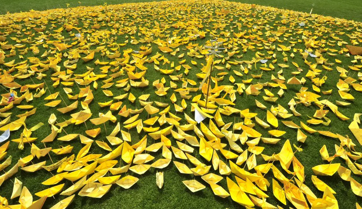 Ribuan kapal kertas kuning bertebaran membentuk hati di Balai Kota Seoul, Rabu (7/5/14). (AFP PHOTO/JUNG YEON-JE)