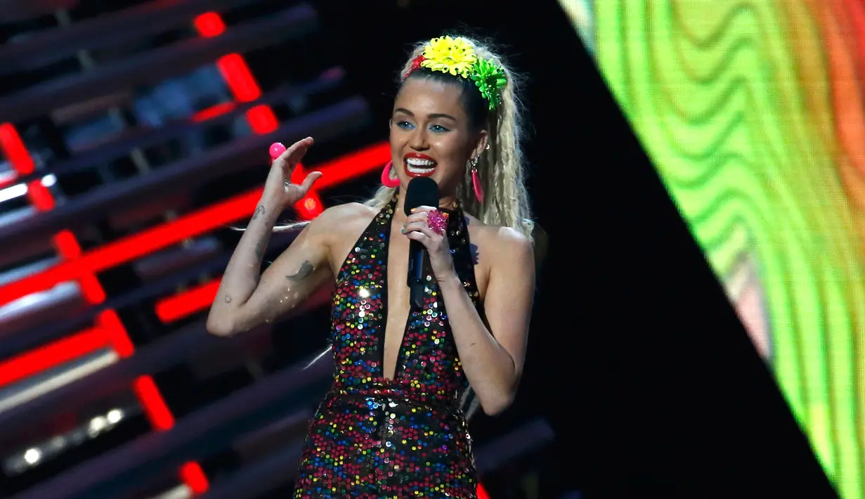 Miley Cyrus berbicara di atas panggung saat menjadi host di ajang bergengsi MTV VMA 2015 yang digelar di Microsoft Theatre, Los Angeles, California, AS (30/8/2015). (REUTERS/Mario Anzuoni)