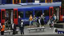 Orang-orang memakai masker setelah turun dari kereta api pada jam sibuk pagi hari di stasiun Waterloo di London, Rabu (13/7/2021). Wali Kota Sadiq Khan menekankan transportasi publik di London akan terus memberlakukan kewajiban memakai masker setelah Senin (19/7) mendatang. (AP Photo/Matt Dunham)