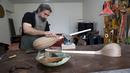 Luthier Ali Akbar Soleimani mengamplas alat musik petik bernama Tanbur yang sedang dibuat di bengkel kerjanya di Teheran, Iran pada 28 Januari 2021. Tanbur merupakan alat musik dawai berleher panjang yang berasal dari kawasan Mesopotamia, Asia Selatan atau Tengah. (AP Photo/Vahid Salemi)