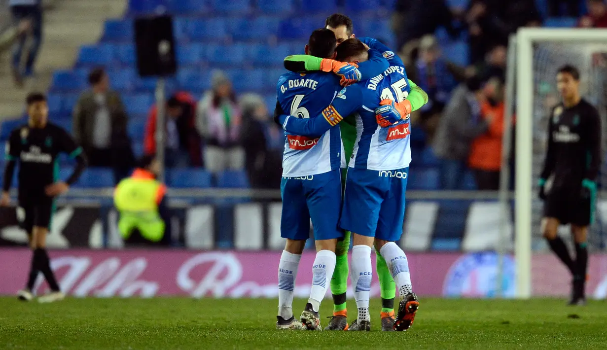 Pemain Espanyol merayakan kemenangan tim mereka atas Real Madrid pada pertandingan pekan ke-26 La Liga, di Stadion RCDE, Selasa (27/2). Real Madrid secara mengejutkan harus takluk dari Espanyol 0-1. (Josep LAGO / AFP)