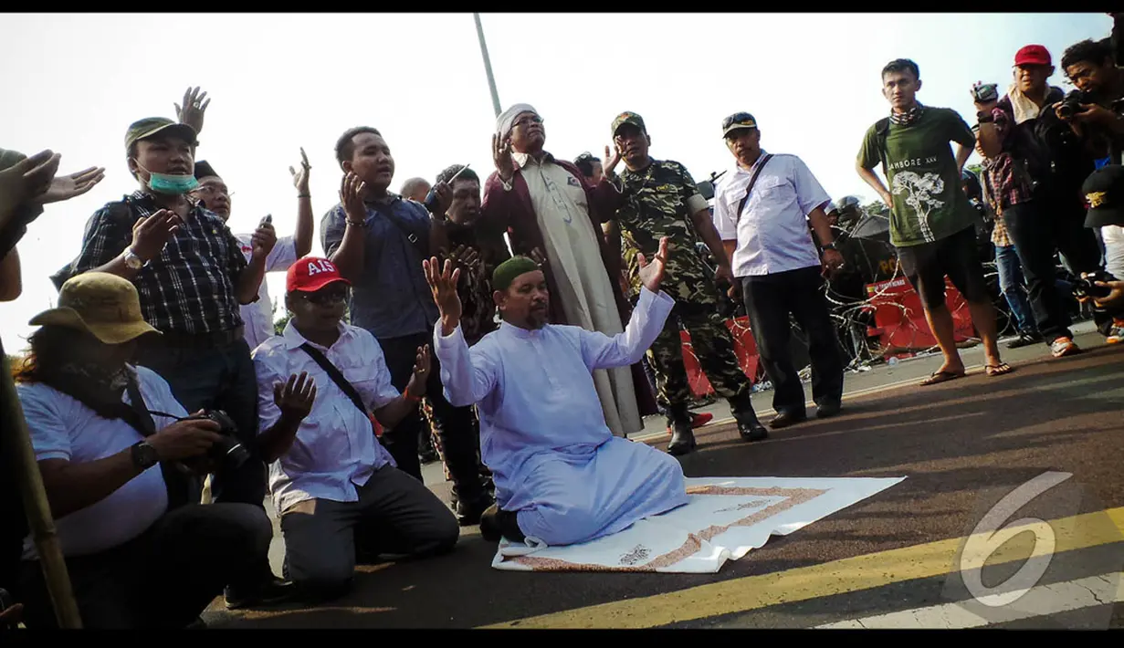 Aksi seorang pendukung yang bergamis putih ini diikuti oleh rekannya. Merekapun berdoa bersama sebagai ungkapan rasa syukur, Jakarta, Kamis (21/08/2014) (Liputan6.com/Faisal Fanani)