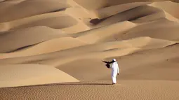 Emirati Ali Mansouri melatih elang di Gurun Liwa, Abu Dhabi, Uni Emirat Arab, Sabtu (9/1/2021). Elang telah terhubung dengan budaya Uni Emirat Arab selama berabad-abad. (Karim SAHIB/AFP)