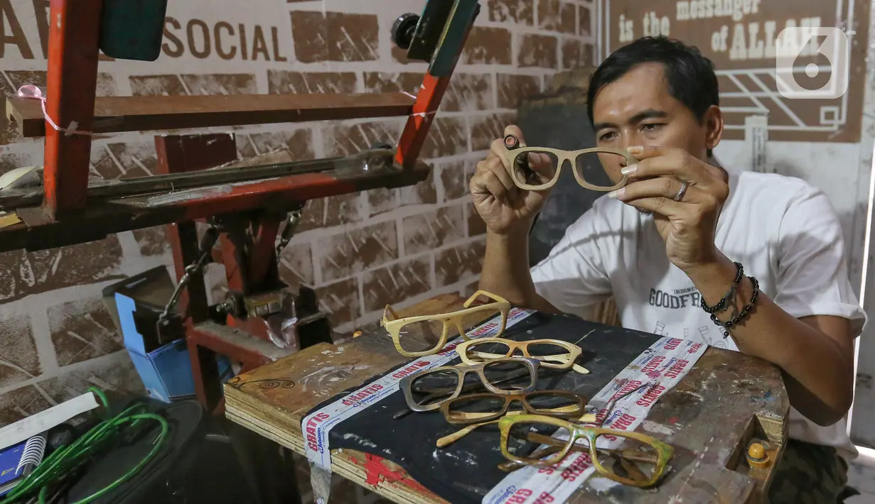 Pengrajin Yuyud, membuat kacamata dari limbah kayu di Jalan Salak, Pamulang, Tangerang Selatan, Senin (13/10/2020). Kacamata dari limbah kayu yang dijual dengan harga Rp 300 ribu hingga diatas Rp 1 juta mampu diproduksi 1-2 frame per hari. (Liputan6.com/Fery Pradolo)