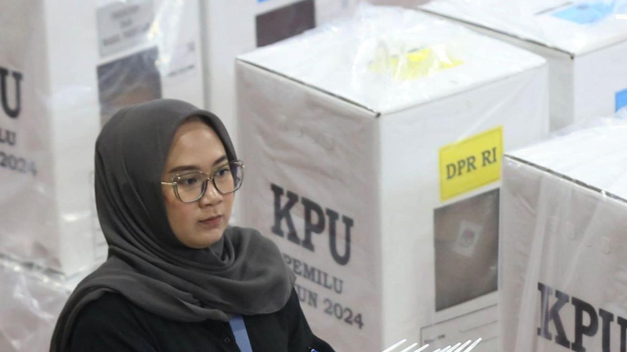 Tampak seorang petugas membawa stiker segel berlogo KPU yang akan ditempelkan pada kotak suara. Foto: merdeka.com / Imam Buhori