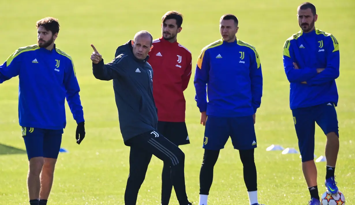Para pemain Juventus mendengarkan instruksi pelatih Massimiliano Allegri selama sesi latihan di tempat latihan Continassa di Turin, Italia (7/12/2021). Juventus akan bertanding melawan Malmo pada Grup H Liga Champions di Allianz Stadium. (AFP/Marco Bertorello)